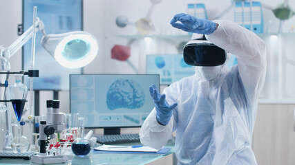 Scientist researcher doctor wearing virtual reality headset analyzing brain activity during...