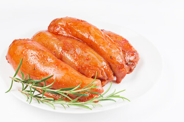 Fresh marinated chicken meat.Raw marinated chicken fillet in red sauce on white isolated background, copy space.