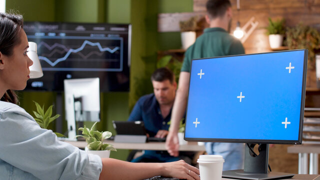 Manager Looking At Mock Up Green Screen Chroma Key Computer With Isolated Display Typing Management Strategy Planning Business Project In Startup Office. Businesswoman Working At Company Presentation