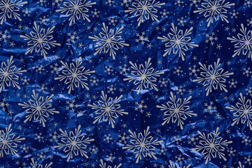 White snowflakes on a blue background wrapping paper. Christmas Holiday concept.