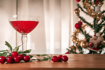 Flavored red fruit cider accompanied by cherries, background Christmas themes