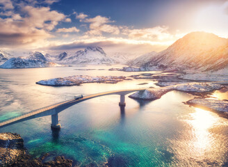 Aerial view of bridge, sea and snowy mountains in Lofoten Islands, Norway. Fredvang bridges at...