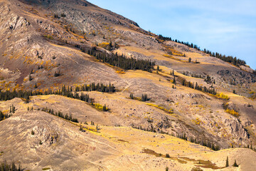 Mountain top in northern Canada during fall, autumn with sparce, isolated and desolate landscape high in the alpine, sub arctic area. 