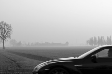 
Travel by car through foggy countryside landscape.