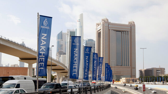 Flags for property company Nakheel are seen on the Sheik Zayed highway in Dubai