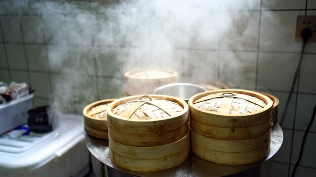 Slow motion of steaming steamed buns bamboo steamer in the breakfast shop kitchen