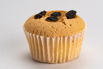Side view of delicious homemade sponge cupcake isolated on white background.