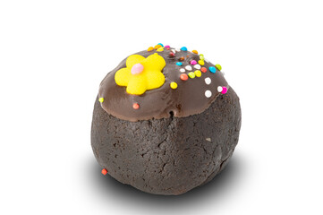 Side view of single chocolate ball topping with rainbow sprinkles and yellow sugar flower.