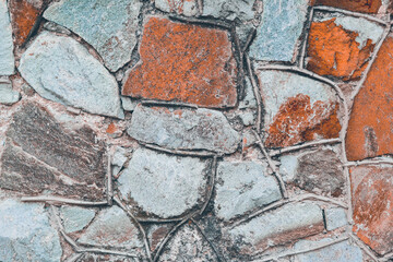 Colorful texture of stone wall with mosaic tiles. Stone Background.