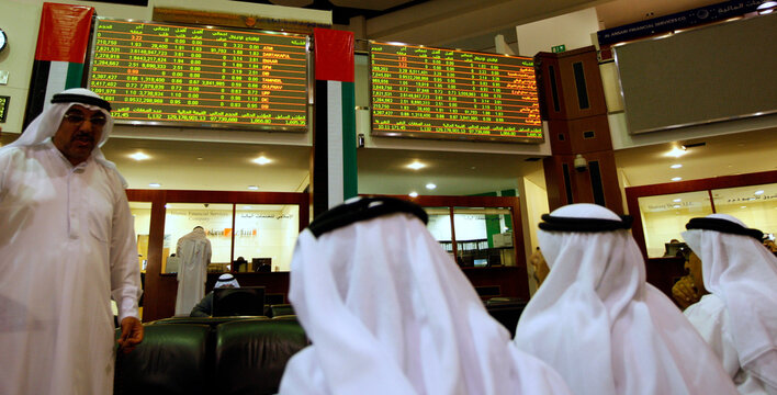 Investors look at stock exchange information in Dubai