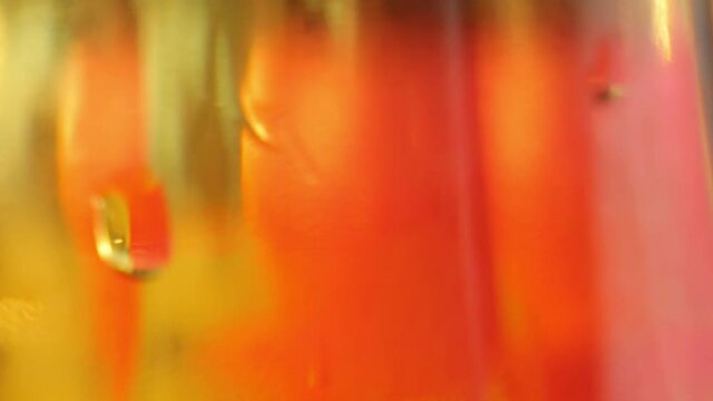 Fruit drink in a bottle close-up. Fruit juice in motion, background.