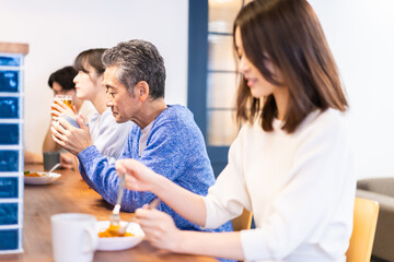 Obraz na płótnie Canvas レストランのカウンター席でご飯を食べる人々