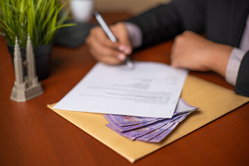 Corrupt Businessman or CEO or Politician hands holding a pen while signing documents or contracts...