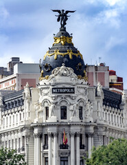 Madrid, Spain - Sept. 28, 2013: Vertical view of The Metropolis Building or Edificio Metrópolis is an office building in Madrid, Spain, at the corner of the Calle de Alcalá and Gran Vía. - obrazy, fototapety, plakaty