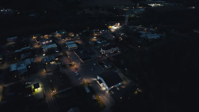Drone Flying Over Small Town at Night