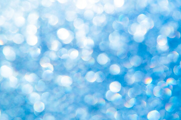 bright glitter background: bokeh effect from many colored lights on frozen glass, toning