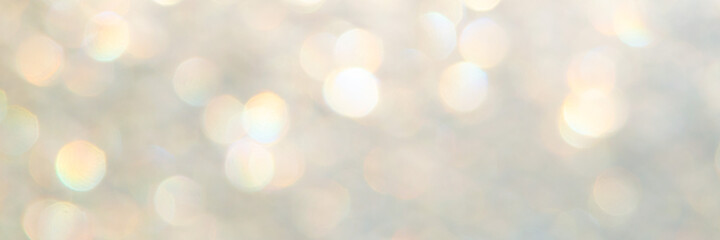 bright glitter background: bokeh effect from many colored lights on frozen glass, toning