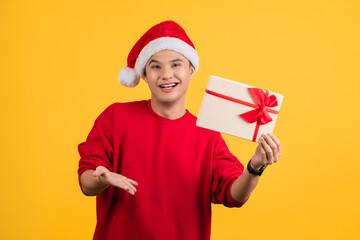 Cheerful young Santa man in red t-shirt, Holding gift certificate. Happy New Year 2022 celebration holiday concept.