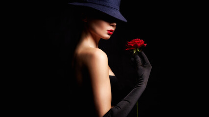 Fototapeta premium Beautiful young Woman In Hat and Flower. Lovely girl weared gloves