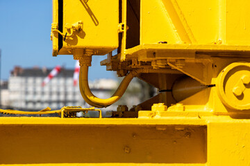 Close up shallow focus of a ywlow Nantes, Titan crane with sunlight with blurred blue sky - obrazy, fototapety, plakaty