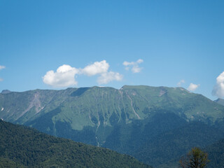 Beautiful green mountains and clouds in resort of Rosa Khutor