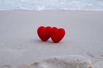 Red heart on a sandy beach concept Valentine day