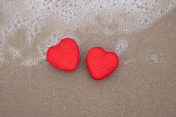 Red heart on a sandy beach concept Valentine day
