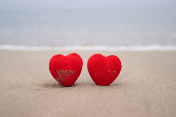 Red heart on a sandy beach concept Valentine day