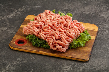 Raw pork minced meat over board