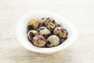 Raw quail eggs heap in the bowl