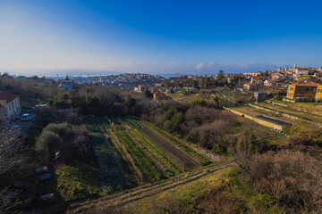 Views from former train track between Trieste and Kozina, above valley of Glinscica or Rosandra on a sunny winter day. View of city of trieste below