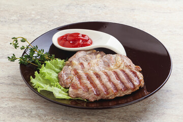 Grilled pork neck steak with ketchup