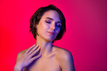 Photo of joyful short hairdo young lady close eyes touch skin without clothes isolated on vibrant red color background