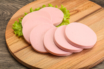 Sliced sausage snak over board