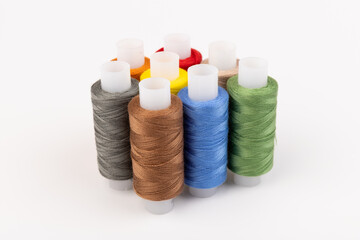 Color sewing threads isolated on white background. Different colors.Bright bobbin thread.