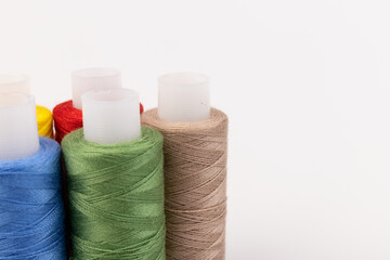 Color sewing threads isolated on white background. Different colors.Bright bobbin thread.