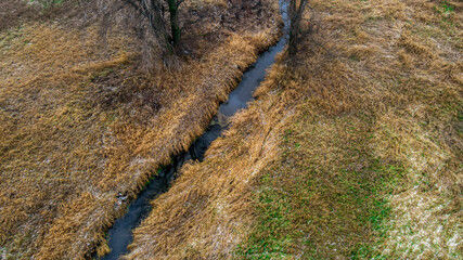 Blue stream flows through rural wisconsin farm lands in autumN