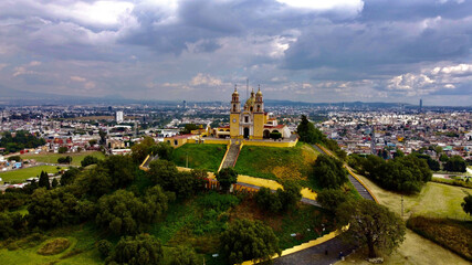 Beautiful view of Cholula Mexico church on a pyramid in Puebla under the cloudy sky