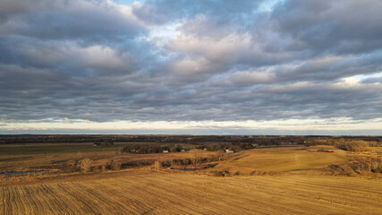Fototapeta na wymiar Dramatic sky over agricultural rural wisconsin farm land