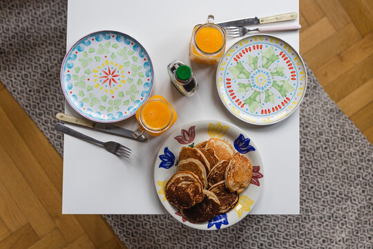 Overhead Shot Of A Plate Of Pancakes And Glasses Of Orange Juice