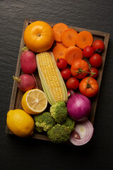vegetable concept different types of vegetables being set on the wooden cutting board on the dark background