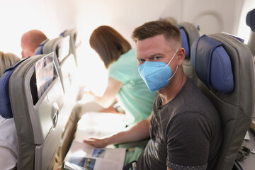Fototapeta na wymiar Couple flying on airplane, reading magazine to kill time