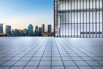 Fototapeta na wymiar Panoramic skyline and modern commercial office buildings with empty square in Shanghai at sunrise
