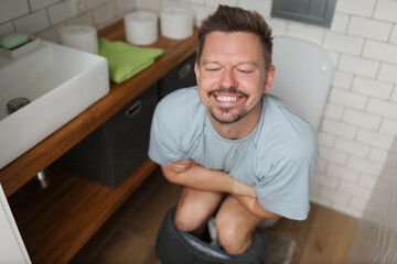 Fototapeta na wymiar Man with happy facial expression after toilet, feel better after defecating