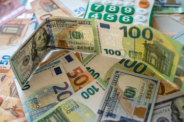 Fototapeta na wymiar calculator on dollar and the euro bills, exchange money