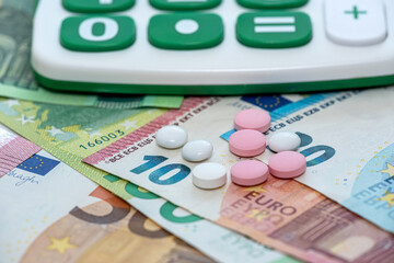 business calculator pharmacy pills and euro banknotes