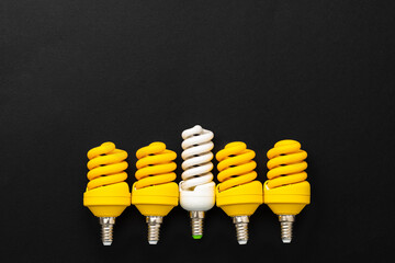 White and yellow light bulbs on black background