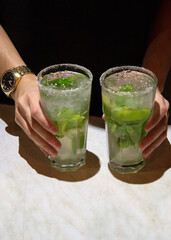 hand holding a glass of lemonade