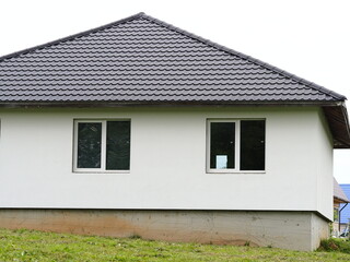building wall of a new house in a village modern construction window and roof