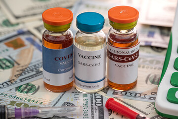 the new high-quality vaccine they brought is next to a calculator and dollar bills.